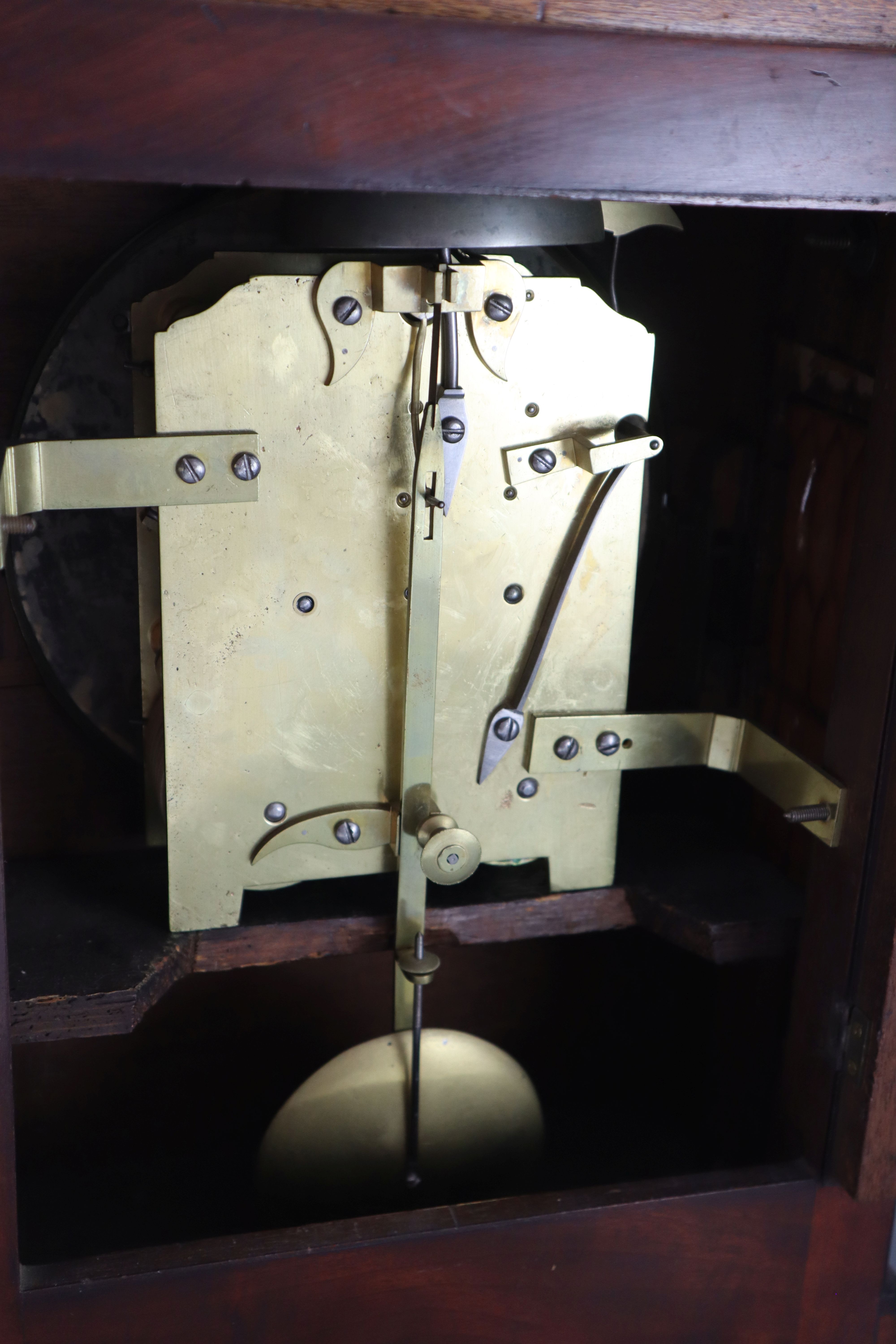 Dwerryhouse & Carter of London. A Regency brass inset mahogany mantel clock, height 19.5in.